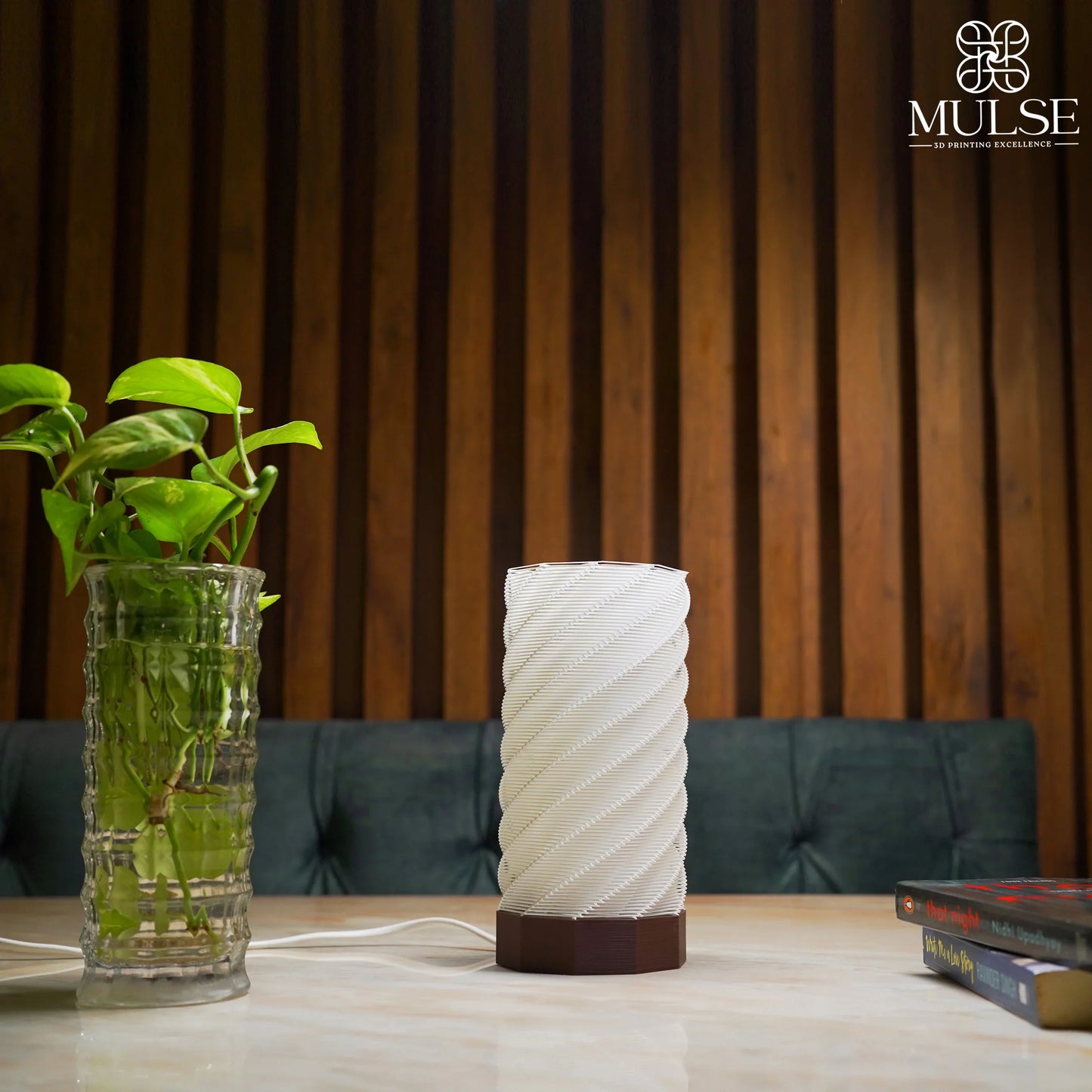 Modern spiral white table lamp with brown base on marble table, indoor decor scene